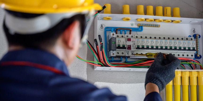 Electrician wiring a commercial distribution board