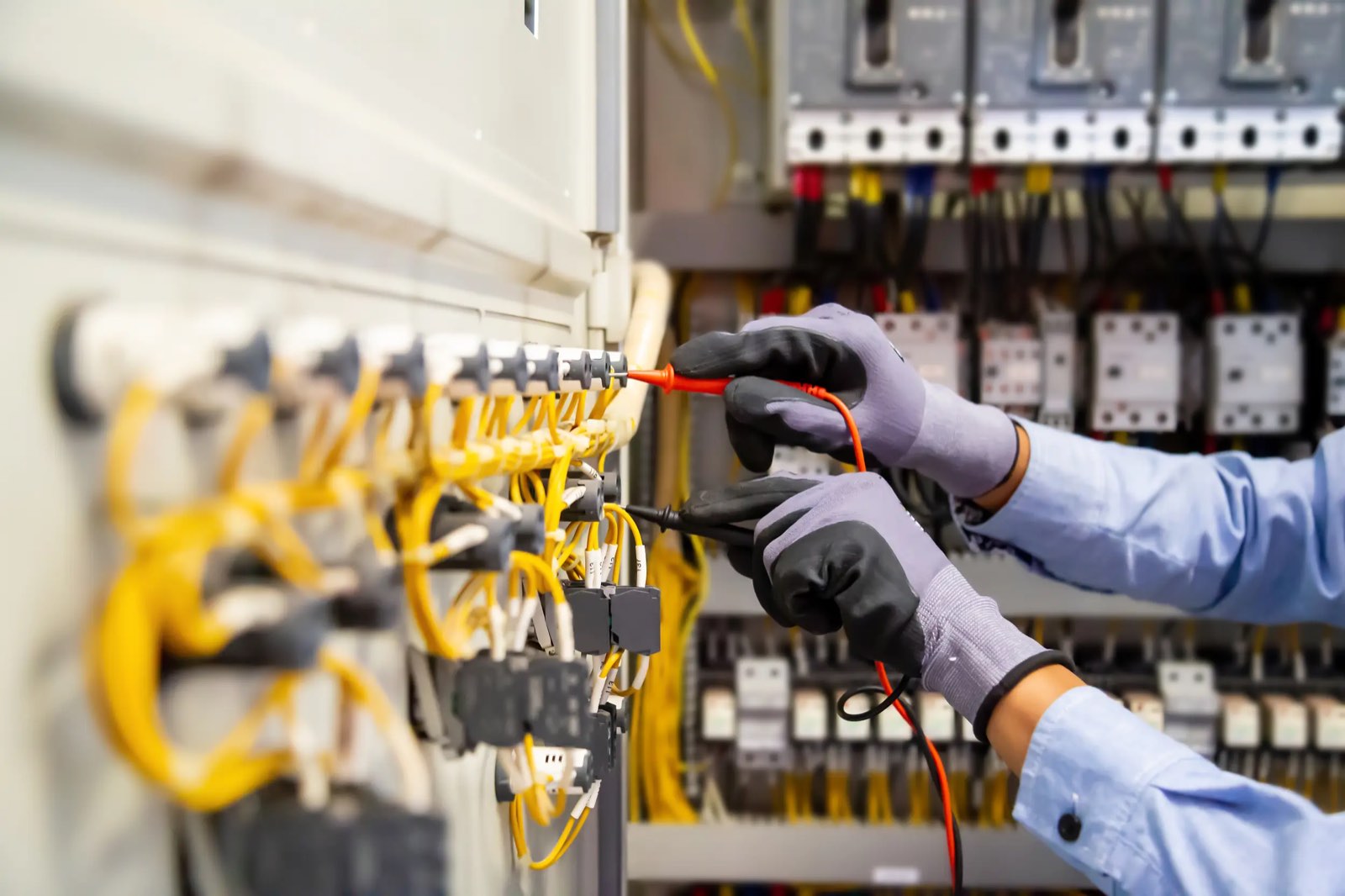 Electrician carrying out testing on a commercial distribution board